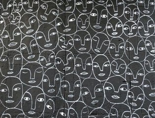Many faces drawn with white line on dark grey background